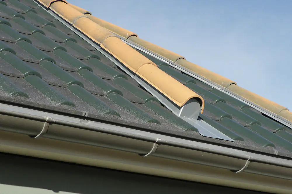Detail van de dakrand met zinken afwerking en dakpannen bij een nieuwe dakkapel